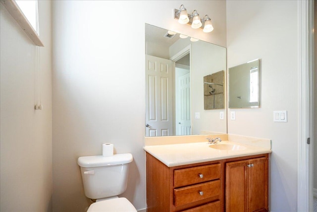 bathroom featuring visible vents, vanity, and toilet