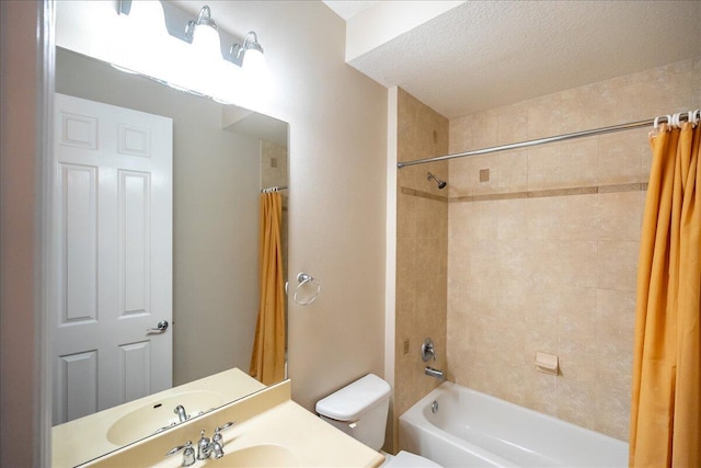 full bathroom featuring a textured ceiling, vanity, toilet, and shower / tub combo with curtain