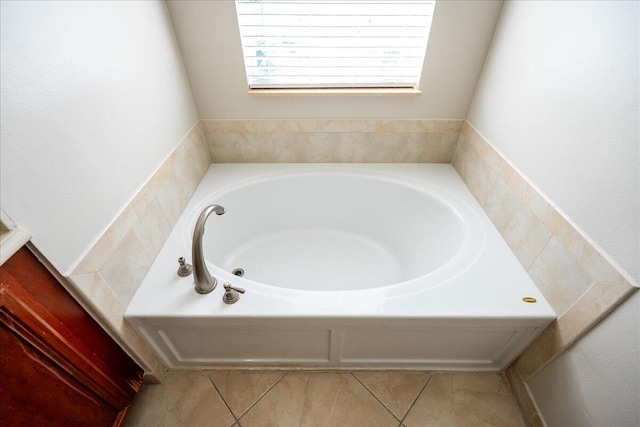 bathroom featuring a garden tub and tile patterned floors