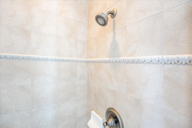 interior details featuring a tile shower