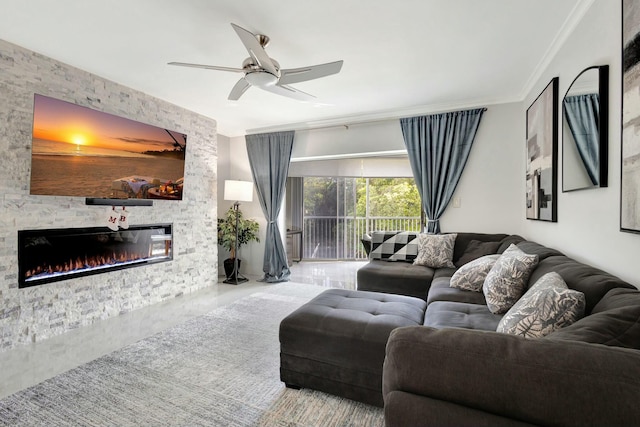 living area featuring a ceiling fan, crown molding, and a stone fireplace