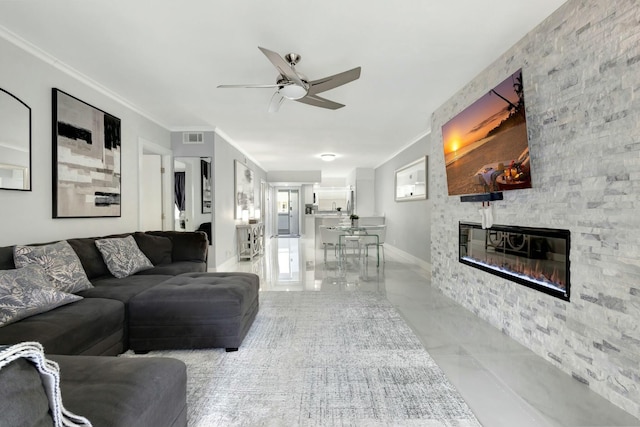 living room featuring ornamental molding, visible vents, a fireplace, and ceiling fan