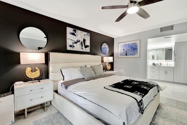 bedroom featuring ceiling fan, visible vents, and ensuite bathroom