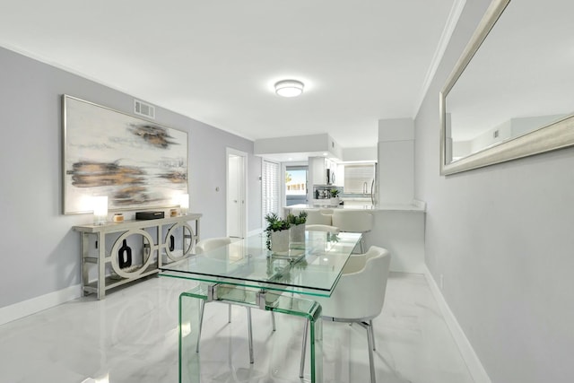 dining room with marble finish floor, visible vents, crown molding, and baseboards