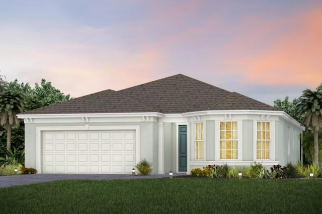 ranch-style home featuring driveway, an attached garage, a yard, stucco siding, and a shingled roof