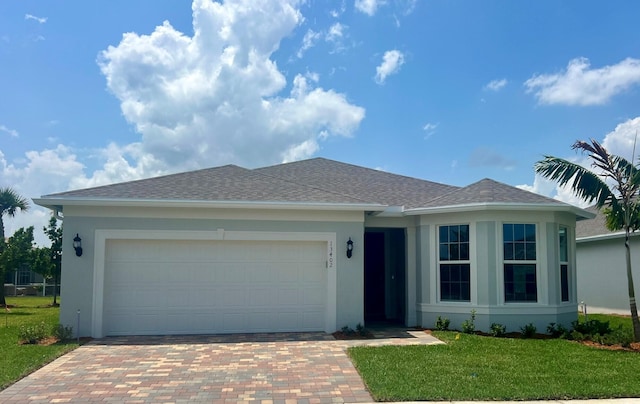 13402 SW Sorella Dr, Port Saint Lucie, FL 34987 - single story home with stucco siding, decorative driveway, a front yard, an attached garage, and a shingled roof