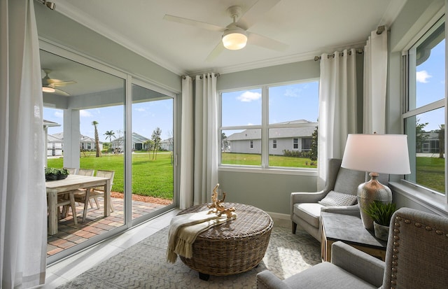 living area featuring ornamental molding, a residential view, tile patterned flooring, and a ceiling fan