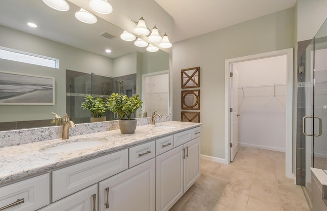 13402 SW Sorella Dr, Port Saint Lucie, FL 34987 - bathroom featuring double vanity, a spacious closet, and a stall shower