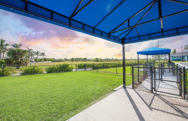 13402 SW Sorella Dr, Port Saint Lucie, FL 34987 - yard at dusk with a gate and a view of rural / pastoral area