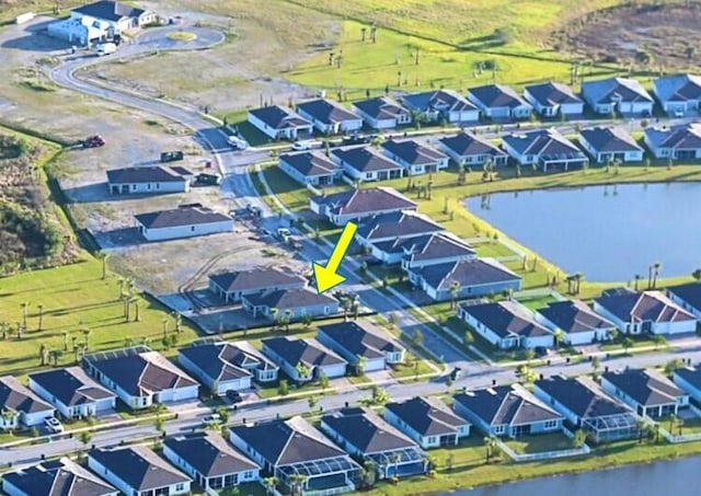 aerial view featuring a residential view and a water view