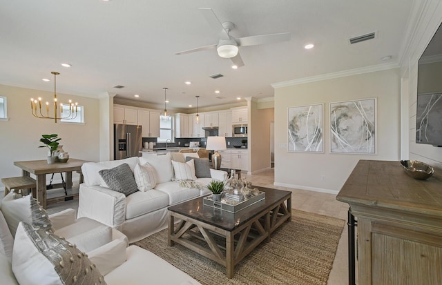 living room featuring ornamental molding, visible vents, and baseboards