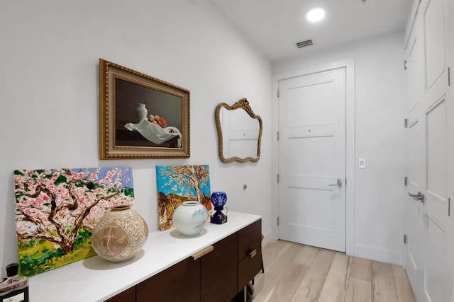 entryway featuring light wood-type flooring, visible vents, and recessed lighting