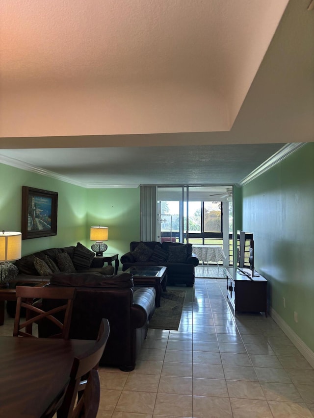 living area featuring ornamental molding, light tile patterned flooring, and baseboards