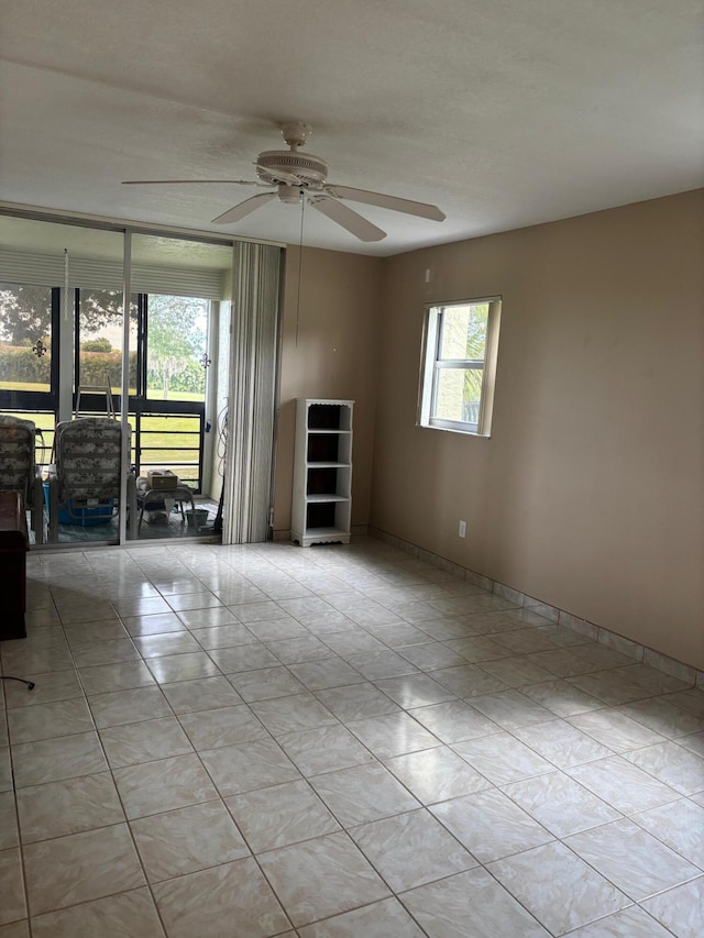 unfurnished room featuring light tile patterned floors and ceiling fan