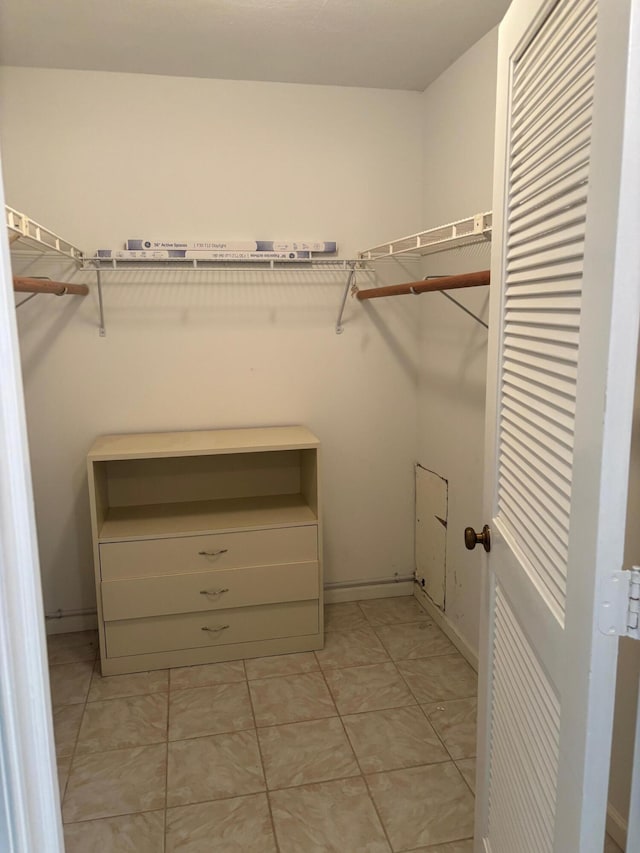 spacious closet featuring light tile patterned flooring