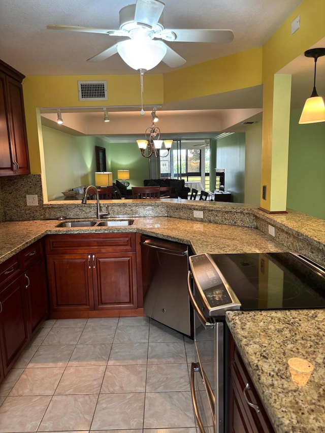 kitchen featuring ceiling fan with notable chandelier, a sink, visible vents, appliances with stainless steel finishes, and decorative backsplash