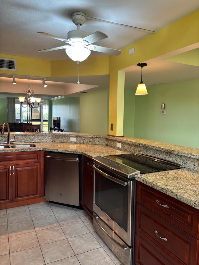 kitchen featuring light stone counters, ceiling fan with notable chandelier, a sink, visible vents, and appliances with stainless steel finishes