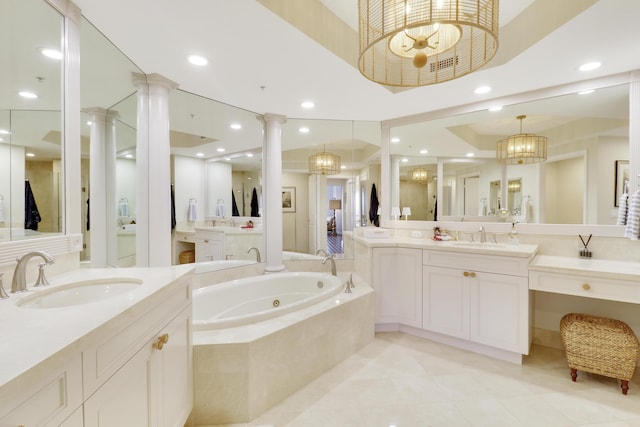 full bathroom with ornate columns, a notable chandelier, and a sink