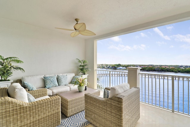 balcony featuring a water view, ceiling fan, and an outdoor hangout area