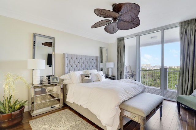 bedroom with crown molding, a ceiling fan, wood finished floors, a wall of windows, and access to outside