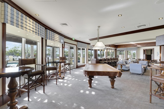 game room with light carpet, ornamental molding, visible vents, and a healthy amount of sunlight