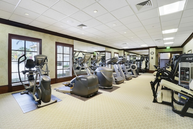 gym featuring baseboards, visible vents, crown molding, and carpet flooring