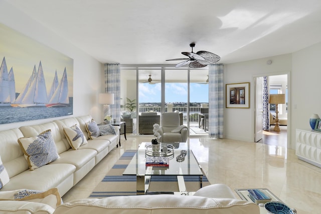 living area featuring baseboards, a wall of windows, and a ceiling fan