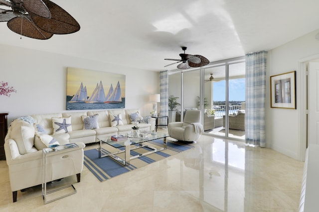 living room featuring a wall of windows, baseboards, and a ceiling fan