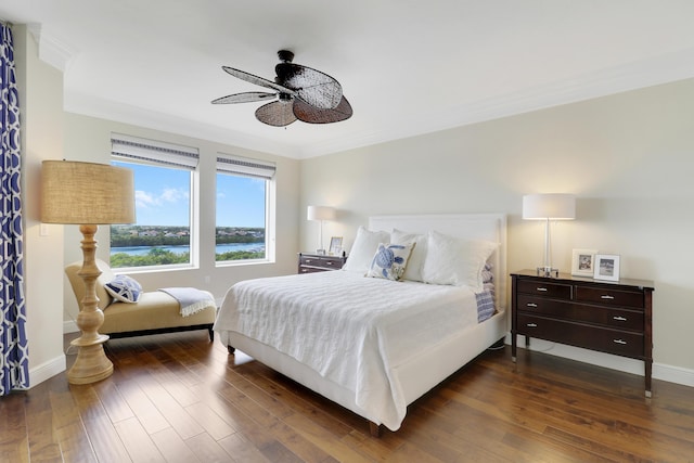 bedroom with ornamental molding, dark wood finished floors, and baseboards