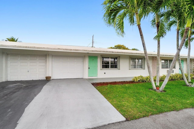 ranch-style home featuring a garage, driveway, a front lawn, and stucco siding