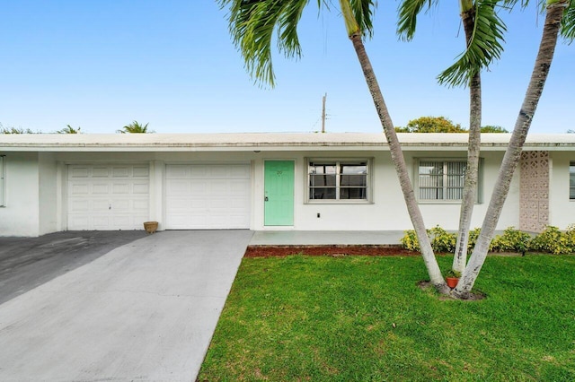 single story home with a front yard, driveway, an attached garage, and stucco siding