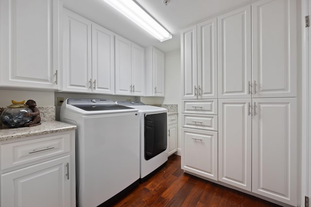 washroom featuring dark wood-type flooring, cabinet space, and washer and dryer