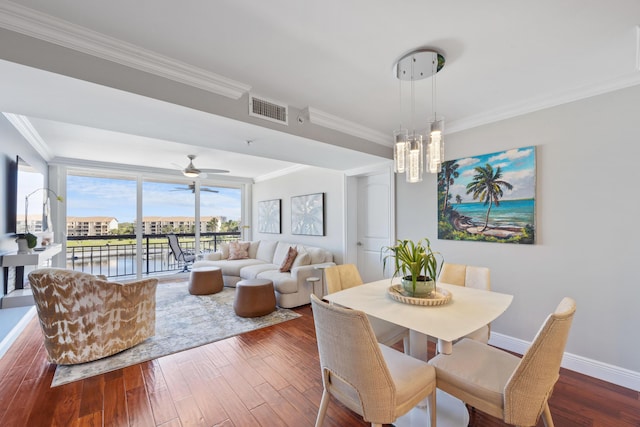 dining space featuring ornamental molding, visible vents, baseboards, and wood finished floors