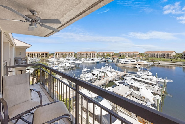 balcony with a water view and a ceiling fan