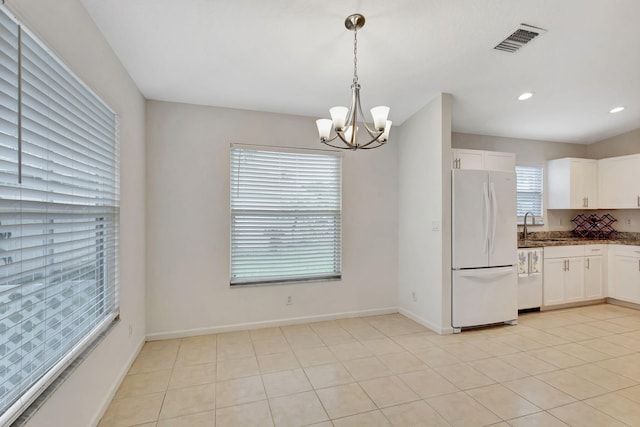 kitchen with visible vents, white cabinets, freestanding refrigerator, dishwasher, and pendant lighting