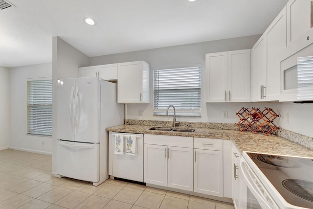 kitchen with visible vents, white cabinets, a sink, light stone countertops, and white appliances