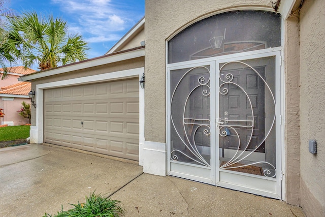 garage with concrete driveway