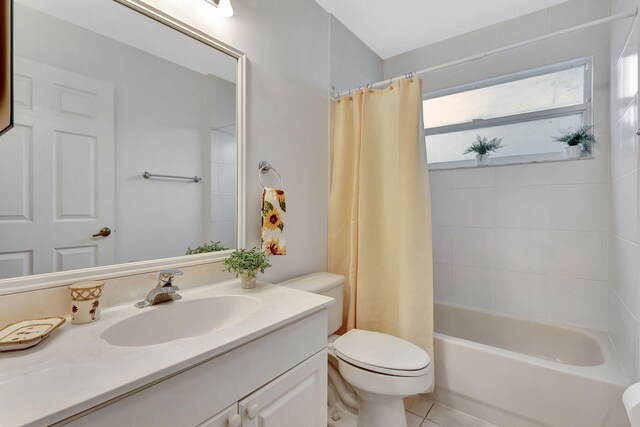 full bathroom featuring shower / tub combo with curtain, vanity, toilet, and tile patterned floors