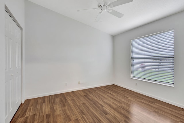 unfurnished room featuring ceiling fan, baseboards, and wood finished floors