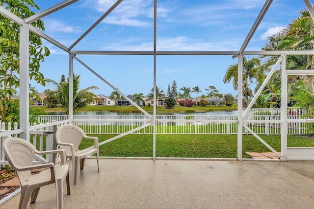 unfurnished sunroom featuring a water view