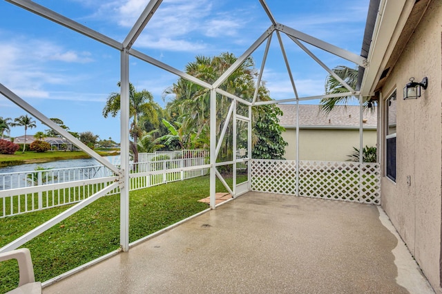 unfurnished sunroom with a water view