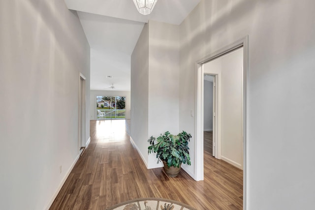 hall featuring baseboards and wood finished floors