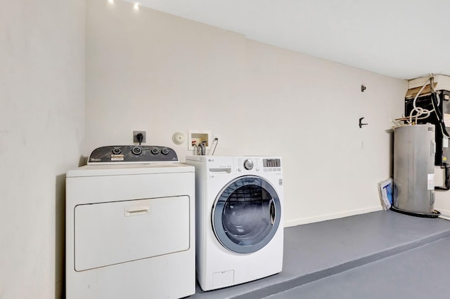 washroom with laundry area, electric water heater, and independent washer and dryer