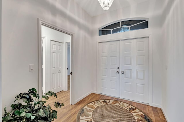 foyer with baseboards and wood finished floors