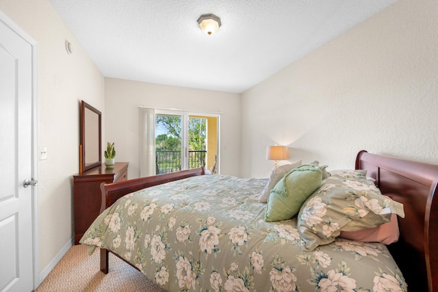 carpeted bedroom with a textured ceiling and baseboards