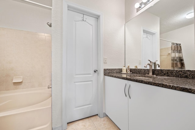 bathroom featuring shower / bath combination with curtain, tile patterned flooring, a textured ceiling, and vanity