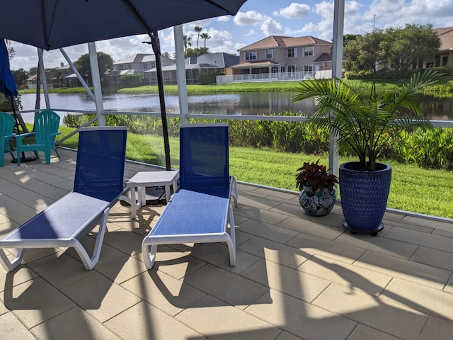 view of patio / terrace with a water view and a residential view