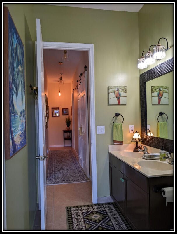 bathroom featuring vanity, baseboards, and tile patterned floors