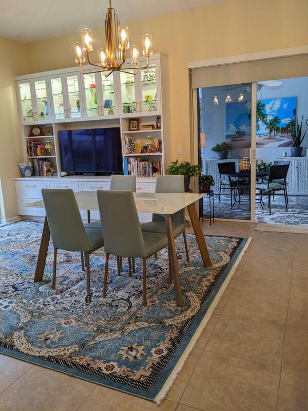 dining room featuring an inviting chandelier and tile patterned floors