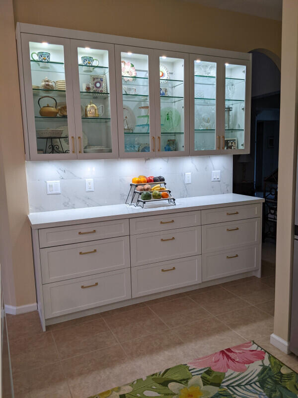 bar with arched walkways, baseboards, decorative backsplash, and light tile patterned floors